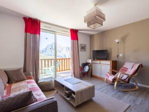 a living room with a couch and a window with a view at Appartement 8 Pers. à Peyragudes avec Piscine Intérieure - FR-1-695-86 in Germ