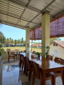 a dining room with a wooden table and chairs at Stella Dell Mare Homestay and Tours in Labuan Bajo