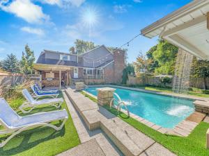 une arrière-cour avec une piscine et deux chaises longues dans l'établissement The Splash & Stay Villa, à Belle River