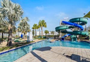 a water slide in a pool at a resort at Stunning Townhouses 5 Minutes away Disney! in Kissimmee