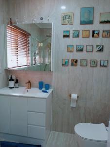 a bathroom with a toilet and a sink and a mirror at Lovely, bright single bedroom, private bathroom, coffee beakfast, relax, near shopping Malls in Collingwood Park