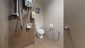 a bathroom with a toilet and a shower stall at Hotel Sayang in Kulai