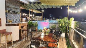 a bar with chairs and a table on a balcony at Milan Corner Hotel in Vung Tau