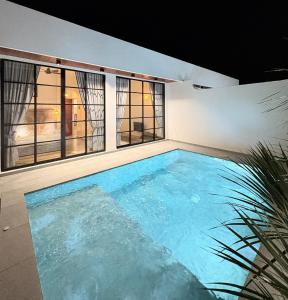 a swimming pool in the middle of a house at Arouna Villa Private Pool in Dungun