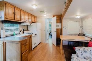 a kitchen with wooden cabinets and a counter top at 2-bedroom Camper Trailer Cottage #1 in Dillon
