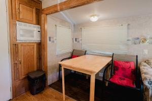 a small room with a wooden table in a trailer at 2-bedroom Camper Trailer Cottage #1 in Dillon