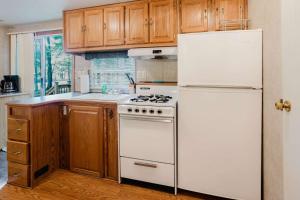 a kitchen with a white stove and a refrigerator at 2-bedroom Camper Trailer Cottage #1 in Dillon +7 photos