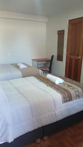 two beds sitting next to each other in a room at Refugio Sagrado Boutique in Cusco