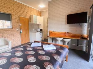 a room with a large bed in a room at Colac Mid City Motel in Colac