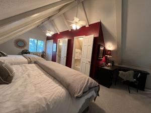 a bedroom with two beds and a desk with a window at The Lofty Cabin at Pettit Bay 