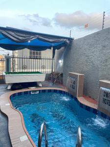 a pool with a ping pong table on a building at Ovation Hotels in Mama