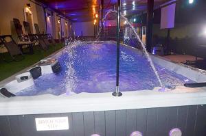 a large jacuzzi tub with a water fountain at Axion Hotel in Owerri
