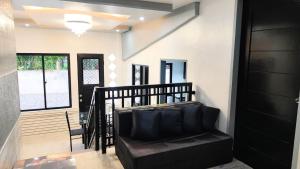 a living room with a couch and a window at Casa Margen in Ormoc