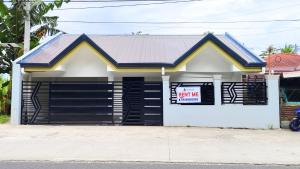 a garage with a sale sign in front of it at Casa Margen in Ormoc