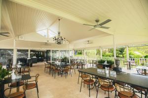 a pavilion with tables and chairs in a restaurant at Aravina Escapes in Yallingup Siding