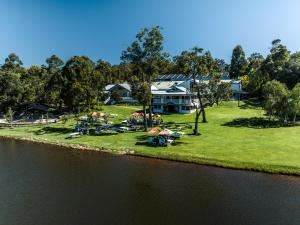 an aerial view of a house on the edge of the water at Aravina Escapes in Yallingup Siding