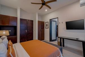 a bedroom with a bed and a flat screen tv at Coral Heaven 4 by Bali Villa Solutions in Badung