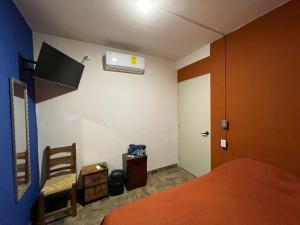 a bedroom with a bed and a air conditioner at verde amanecer in Xilitla