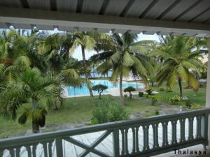 a view from the balcony of a resort with palm trees at 11 residence thalassa in Belle Mare