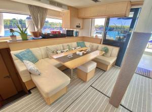 a living room and dining room on a yacht at Spacious 52' Sailboat | 6 Cabins | Dockside Escape in Key West