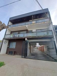 a building with an open garage door with stairs at Departamento privado a pasos del centro in Constitución