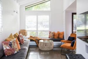 a living room with a couch and a window at The Coconut Palm TWO in Sunshine Beach