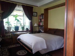 a bedroom with a large bed and a window at Phoenix House B&B in Stettler +10 photos