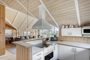 a large kitchen with white cabinets and a stove at SB56207-Sydals-Solbjergvej-26 in Sønderby +13 photos