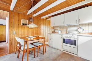 a kitchen with white appliances and a wooden ceiling at SB53859-Broager-Pilevej-4 in Vemmingbund +14 photos