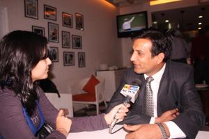a woman talking to a man with a microphone at Hotel BLUE DIAMOND in Jāmb