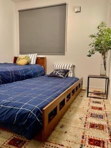 a bedroom with two beds and a large screen at Tanuki House No. 2 ! Shinjuku！Nearest Station 1 min, Over 100㎡ in Tokyo