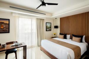 a hotel room with a large bed and a desk at Kadun Hotel Boutique in Cabo San Lucas