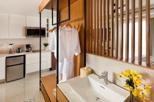 a kitchen with a sink and a white shirt on a rack at Kadun Hotel Boutique in Cabo San Lucas +16 photos