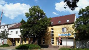 a large brick building with a red roof at Hotel Zannam in Brno