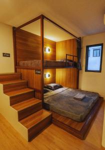 a bedroom with a bunk bed and a staircase at hotel Rue de Saim in Bang Rak