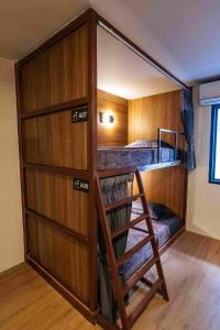 a room with a bunk bed and a ladder in it at hotel Rue de Saim in Bang Rak