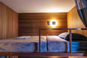 a bedroom with a bed with a wooden wall at hotel Rue de Saim in Bang Rak