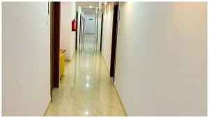 a hallway of an office building with a long corridor at Premium Facilities Hotel R A T R E E - Comfortable and Serene Stay in Bhopal +1 photo
