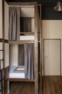two bunk beds in a room with a door at Black Swan Hostel Sevilla in Seville +49 photos