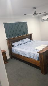 una camera da letto con un letto in legno con un tetto verde di Brassall Haven Retreat a Coalfalls 1 altra foto