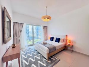a bedroom with a bed and a large window at Modern City Escape Gate Towers Al Reem in Abu Dhabi +47 photos