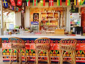 three chairs sitting at a bar in a restaurant at Amwani Beach Camp - Mini Glamping Tent in El Nido