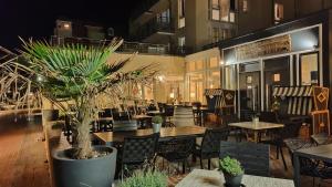 an empty restaurant with tables and chairs and plants at Hund im Glück in Wangerooge