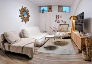 a living room with a couch and a table at Appartement Cocooning Béziers Cœur historique, charme et confort noté 10 in Béziers