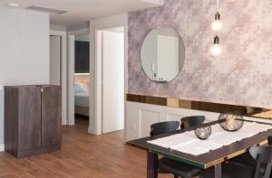 a dining room with a table and a mirror at Residence Ten Suite in Rimini +46 photos