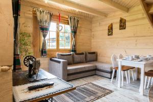 a living room with a couch and a table at Domek z Widokiem Harenda View Cottage with a view Harenda View-Zakopane in Zakopane