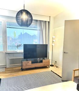 a living room with a large flat screen tv at Midnight Sun center apartments in Sodankylä