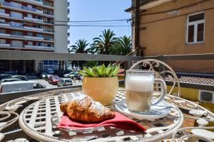 a table with a glass of milk and a cup of coffee at Rooms Urban design in Zadar
