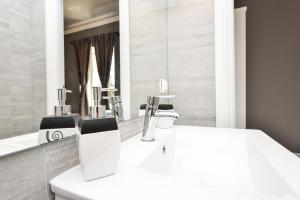 a bathroom with a sink and a mirror at Rooms Urban design in Zadar +44 photos
