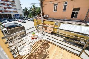 a balcony with a table and chairs on a balcony at Rooms Urban design in Zadar